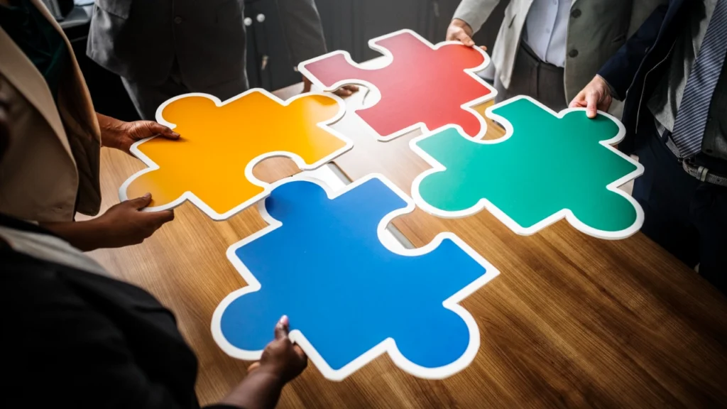 Team joining puzzle pieces for capacity development