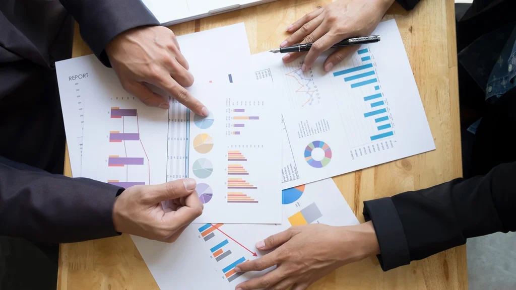 Impact consulting team evaluating project growth charts