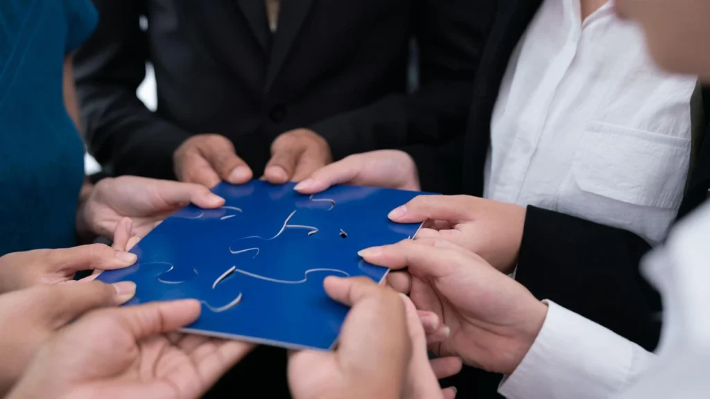 Social impact consulting team aligning puzzle pieces together